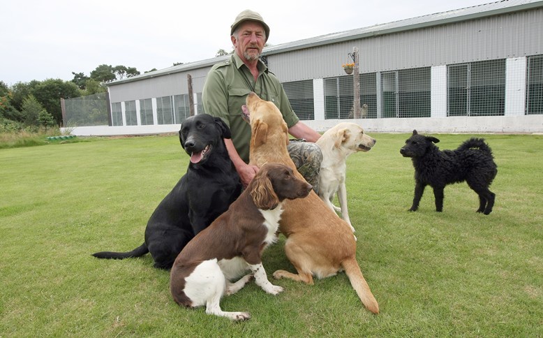 Kim Cessford, Courier - 06.08.10 - Andy Ritchie of Moorie Boarding Kennels disputes the value of the kennel cough vaccine - words from Liz in Montrose - pictured is Andy with some of his own dogs in front of the kennels.