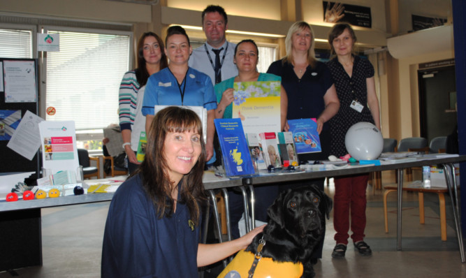 Standing, from left: Lee Foggarty, Kerry Queen, Andy Shewan, Leigh-Ann Whyte, Frances Taylor and Ann Harland. Kneeling: Shirley Stewart with dementia dog Alex.