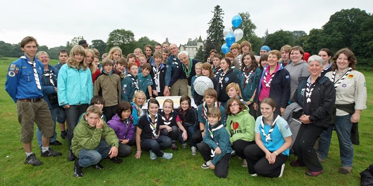 Kim Cessford, Courier - 06.08.10 - the 25th anniversary of exchange visits between Tayside and Swedish Scouts was marked at Cortachy Castle where the first exchange camp was held - pictured with scouts old and new are centre group cutting the celebration cake - l to r - Sheila Hanlin (Camp Leader), Mattias Andersson (Head of Vedum Scout Group) and Lord Airlie