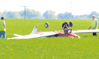 The plane came to a rest upside-down in a field.