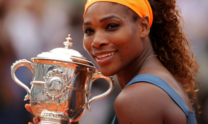 Serena Williams ended her 11-year wait for French Open success with victory over Maria Sharapova.