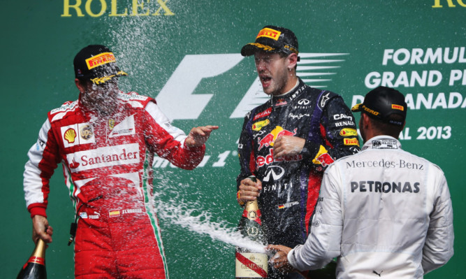 Sebastian Vettel, centre, celebrates with Fernando Alonso, left, and Lewis Hamilton.