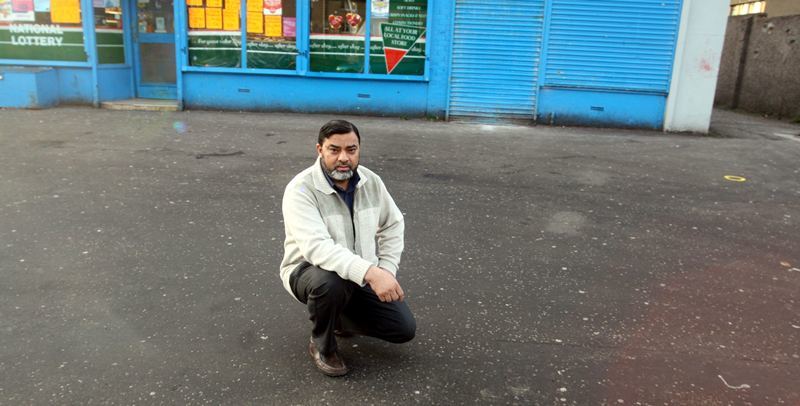 Mr Mohammed Bashir Chohan beside a bollard marking outside his store in Balmoral Terrace, Dundee.