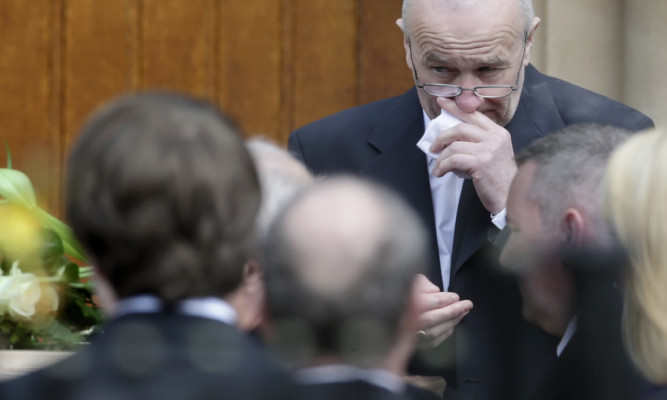 Tom McDonough looks at the coffin of his daughter Nicola, following the funeral of his wife Margaret and their daughter.