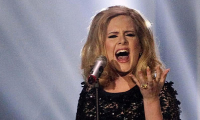 Adele has added an MBE to get collection of honours.
