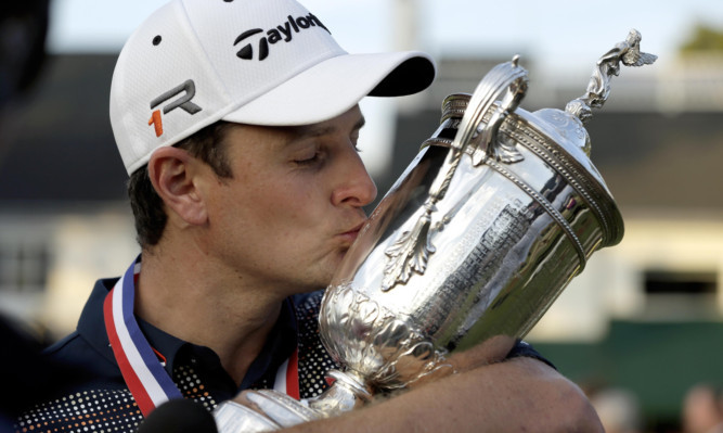 Justin Rose, of England, kisses the trophy after winning the U.S. Open.