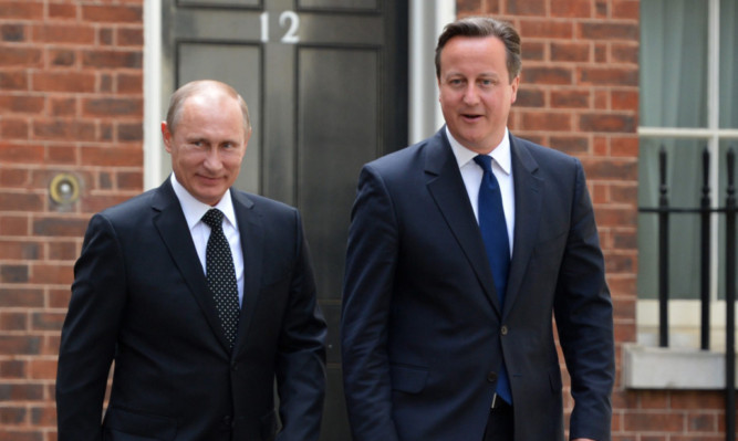 David Cameron greets  Russian President Vladimir Putin in Downing Street.