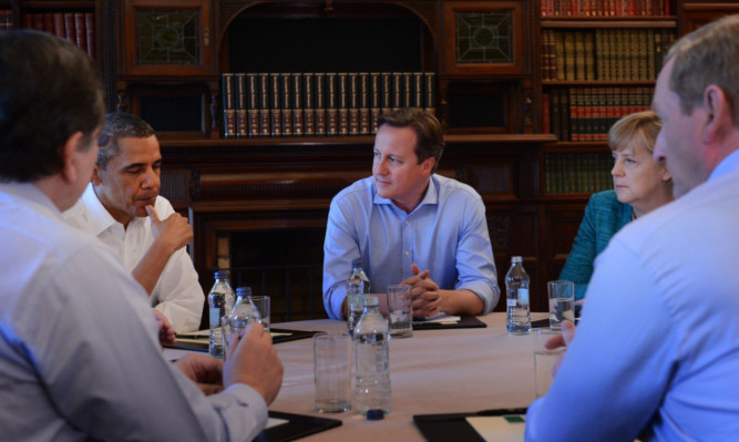 Prime Minister David Cameron chairs an EU/US trade summit with US President Barack Obama (left), German Chancellor Angela Merkel (right) and French President Francoise Hollande (not pictured).