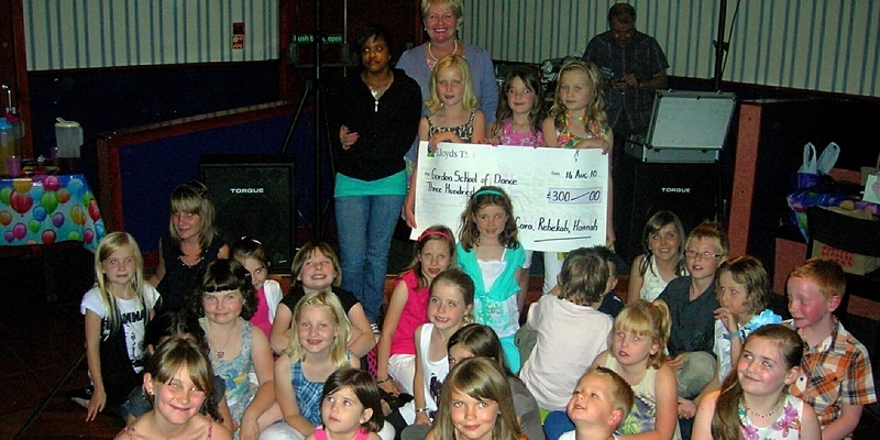 Chris Hardy, Courier. Pic shows Montrose birthday party cheque presentation to Trinidad girls awaiting life changing operation. The party, catered for by The Sweetest Thing Parties was held at The Yard, George Street, Montrose. Pictured from the back left are Kade, Robina, Hannah, Rebekah and Cara with the cheque along with all their friends and family who attended the party. See Montrose copy.