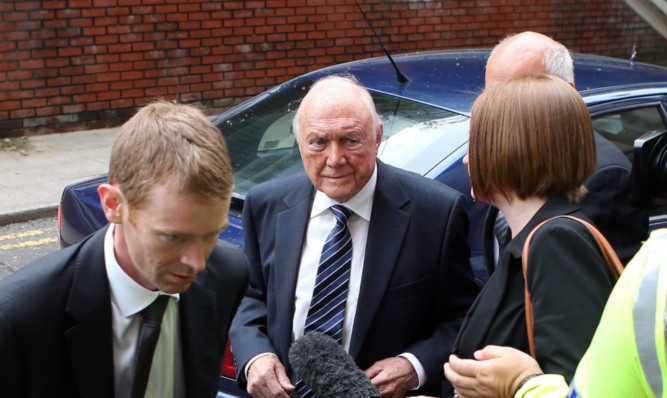 Stuart Hall (centre) arriving for sentencing.