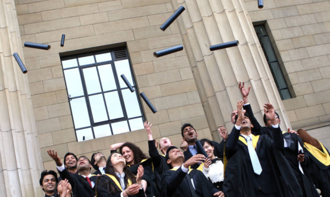 Last year's graduands celebrating in traditional style.