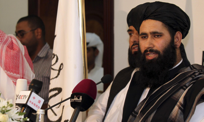 Muhammad Naeem, a representative of the Taliban, speaks during a press conference at the official opening of their office in Doha.