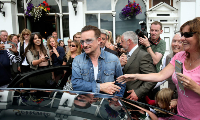 Bono leaves Finnegans in Dalkey after having lunch with the Obamas.