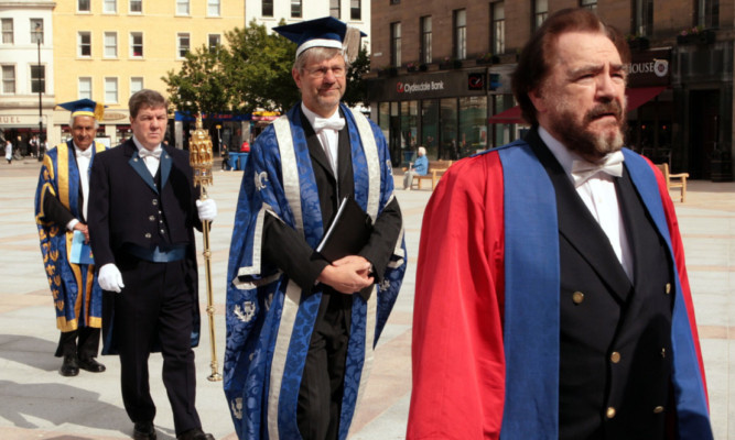 Rector Brian Cox followed by principal and vice-chancellor Professor Peter Downes as they make their way in procession to the Caird Hall.