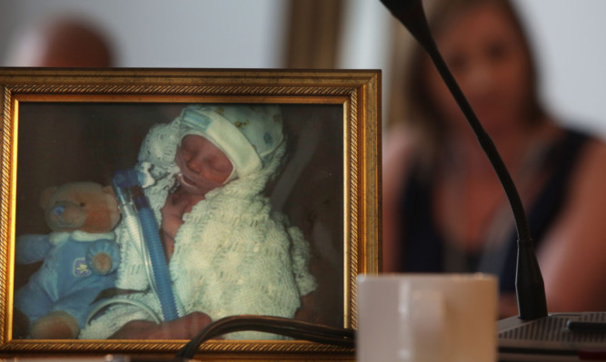 Parents took pictures of their dead infants to the Scottish Parliament as part of their campaign for a public inquiry.