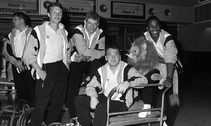 File photo dated 03/06/1989 of Members of the British Lions squad at Heathrow Airport waiting to jet to Australia to start their tour. From left, unidentified, Paul Dean (St Mary's College, Ireland), captain Finlay Calder (Stewart's Melville and Scotland), Ieuan Evans (Llanelli and Wales) and Chris Oti (Wasps and England) with the team's toy baby lion mascot.