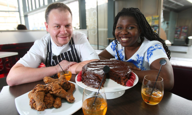Chef Martin Buchan and culinary consultant Peggy Brunach with some of the dishes that will be on offer  a cola cake, fried chicken and a bourbon/whisky cocktail.