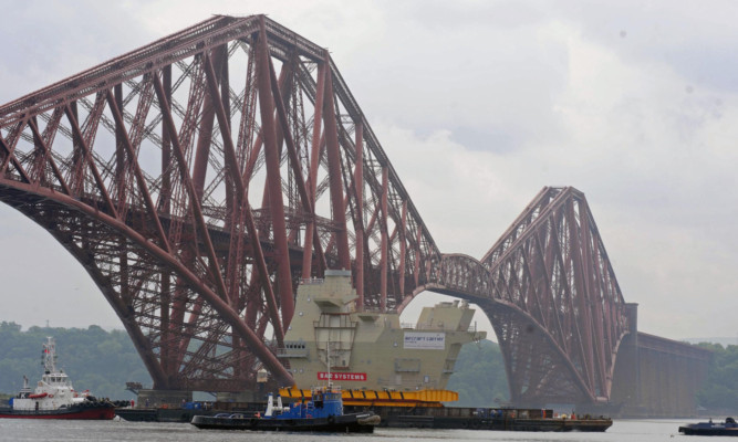 The final section of HMS Queen Elizabeth, Upper Block 14, passing under the Forth Bridge.