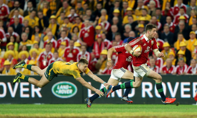 Alex Cuthbert evades the tackle of Australias James OConnor to run in a try for the Lions.