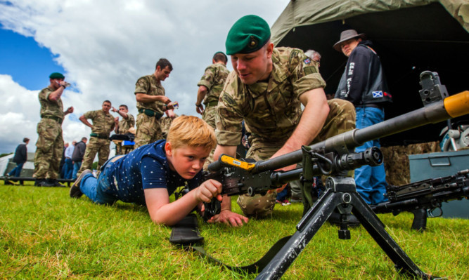 Nathan Campbell gets to grips with a general purpose machine gun, alongside Marine Sam Barton.