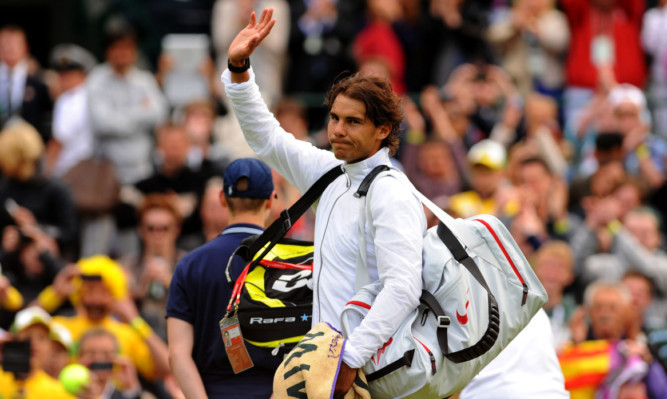 Spain's Rafael Nadal waves to the crowd after losing to Belgium's Steve Darcis.
