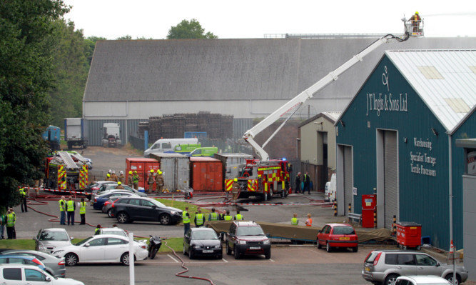 Crews tackle the fire at J T Inglis & Sons.