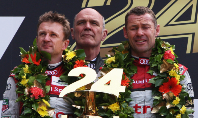 Allan McNish, Dr Wolfgang Ullrich and Tom Kristensen on the Le Mans podium.