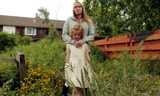 Robyn with her niece Katelyn in the overgrown garden.