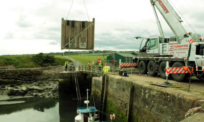 The gates being lifted into position.