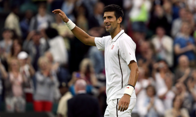 Serbia's Novak Djokovic celebrates beating USA's Bobby Reynolds.