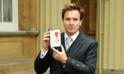 Actor Ewan McGregor holds his OBE medal.