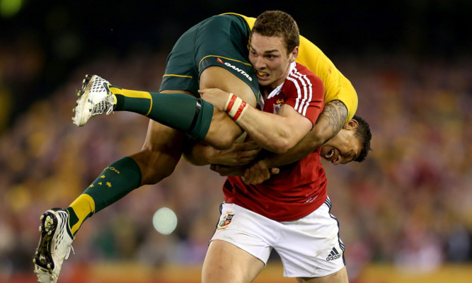 The Lions' George North carries Australia's Israel Folau during the second test.