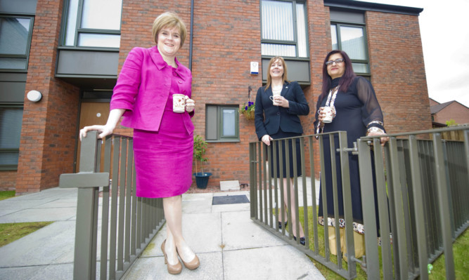 Deputy First Minister of Scotland Nicola Sturgeon meets with tenants from the Oban Drive development in Glasgow.