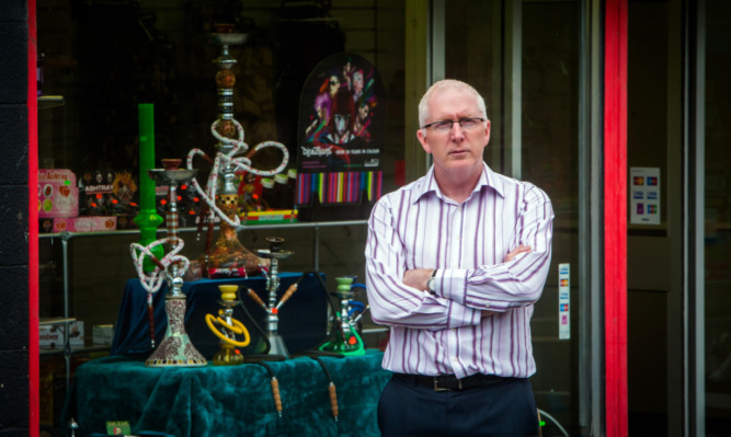 Rev Martin Fair outside a legal high shop, two doors down from his community centre.