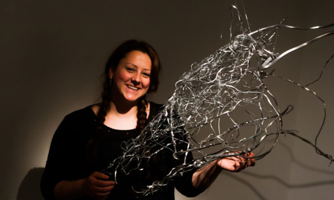 Jennifer Robson alongside her piece The Horse, made of aluminium wire.