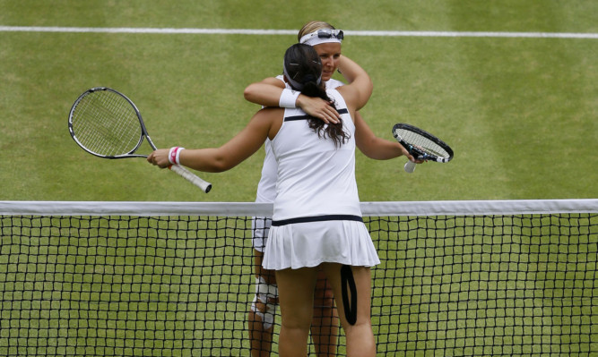 France's Marion Bartoli hugs Belgium's Kirsten Flipkens following her semi-final victory at Wimbledon.