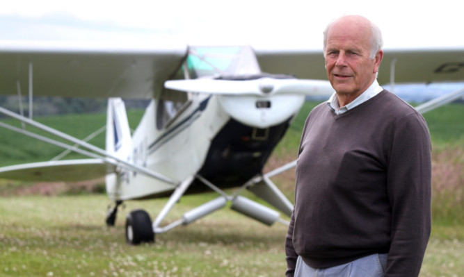 Disappointed volunteer search pilot Stewart Russell shows off his plane at his home.