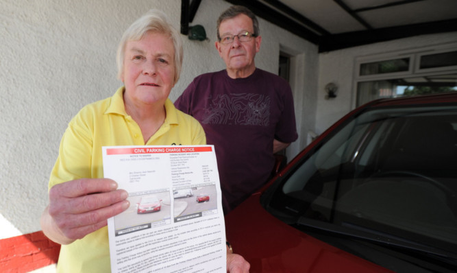 Sheona and Don Naismithwith the parking fine notice.