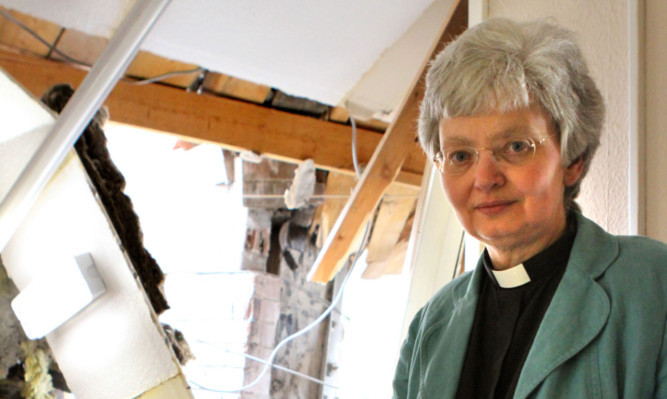 The Rev Alison Jones and the damage caused to the church hall.