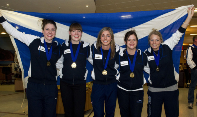Eve Muirhead (centre) and her team returning to Scotland as world champions in March.