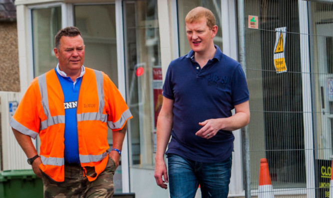 Mr Clark speaks to Neil Thomson, of construction firm Diack & Macaulay Ltd, thanking the company for finishing ahead of schedule.