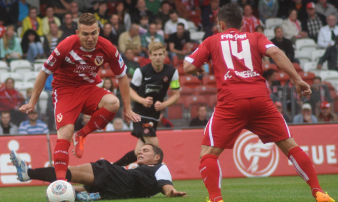 John Rankin attempts to stop a Cottbus break with a sliding challenge.