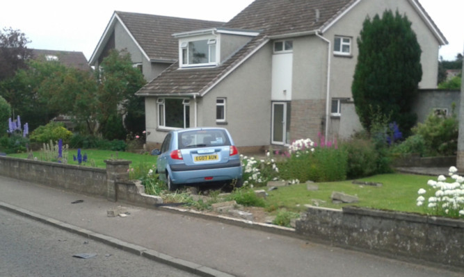 The Hyundai came to rest in a garden. The other driver was charged by police.