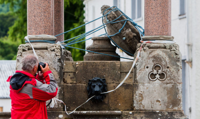 The damaged fountain makes an unusual photo for Swis visitor Hans Weibel.