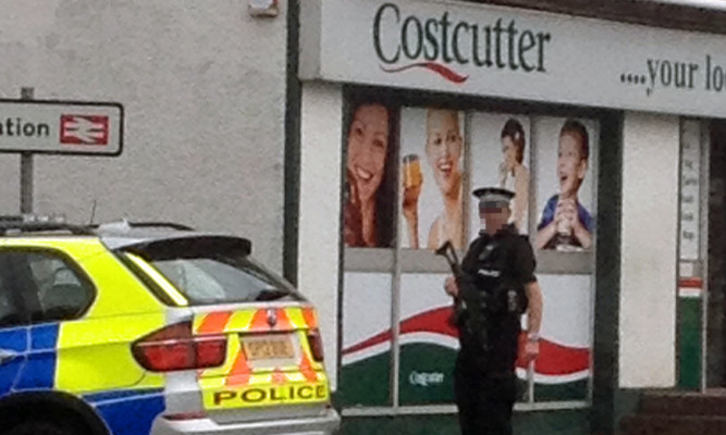 A Courier reader's photo of an armed officer outside the store in Kinghorn.