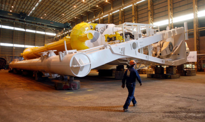 A worker inspects Aquamarine Powers next-generation Oyster 800 at BiFab in Methil.