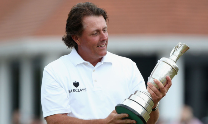 Phil Mickelson gets his hands on the most coveted prize in golf.