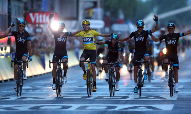 Chris Froome crosses the line with his SKY Procycling teammates.