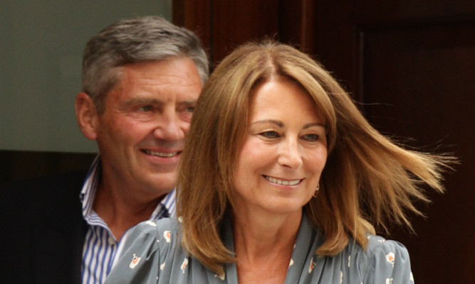 Carole and Michael Middleton leave the hospital after being among the first to see the new prince.