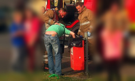 Firefighters help to free the woman.